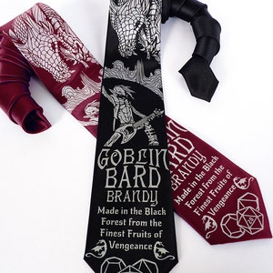 May include: Two neckties with a dragon and a goblin bard design. The black tie has the text "Goblin Bard Brandy Made in the Black Forest from the Finest Fruits of Vengeance" and a 20-sided die. The burgundy tie has the same text and die design.