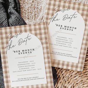 May include: Two cards with a beige and white gingham pattern, featuring the text "Save the Date" and "'BER MONTH EVENTS". The cards list event dates for Halloween, Friendsgiving, Cookie Decorating, and East Coast New Year's Eve. The background is neutral.