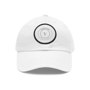May include: White baseball cap with a curved brim. The cap features a circular patch with the text "YUMETEES" in a ring around a "Y" and the words "WEAR YOUR DREAM". The patch is black and white.