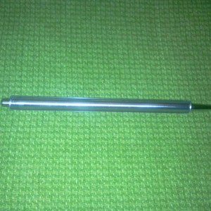 May include: A silver crochet hook with a pointed tip and a rounded handle.