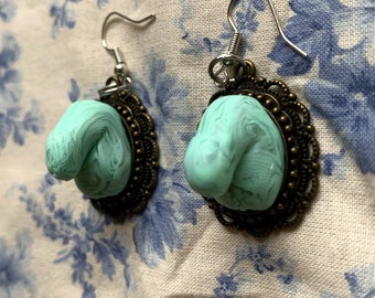 Hand sculpted mint green and translucent swirl penis earrings