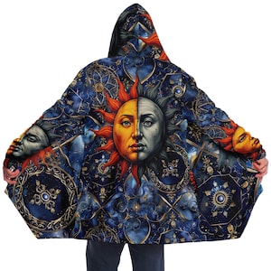 May include: A hooded cloak with a blue and gold background featuring a repeating pattern of a sun and moon with a human face. The sun is orange and yellow, and the moon is gray and white.