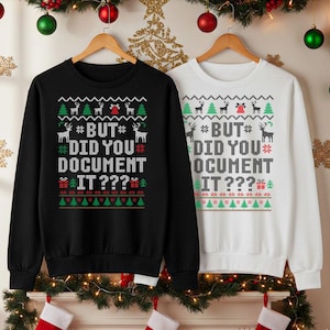 Peut inclure: Deux sweatshirts à col rond, un noir et un blanc, avec un motif de Noël. Le motif comprend des rennes, des sapins de Noël et le texte "BUT DID YOU DOCUMENT IT???" en vert, rouge et blanc.