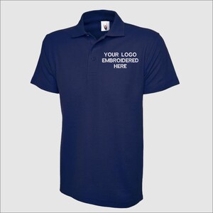 May include: A navy blue polo shirt with short sleeves and a white embroidered logo that says "YOUR LOGO EMBROIDERED HERE".