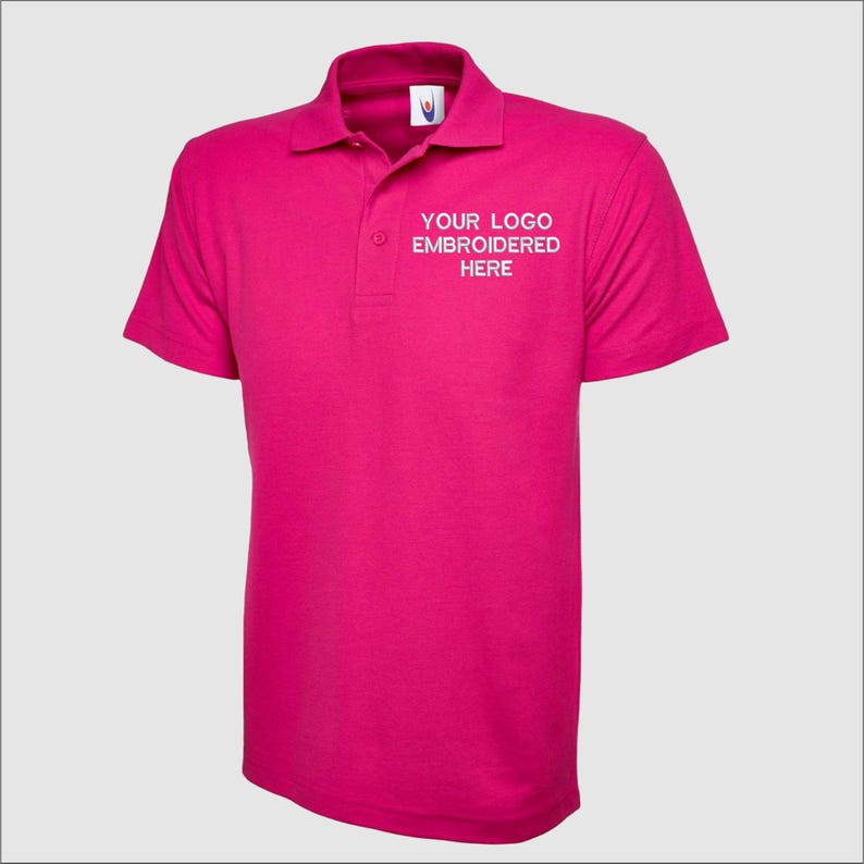 May include: A pink polo shirt with short sleeves and a white embroidered logo that says "YOUR LOGO EMBROIDERED HERE".