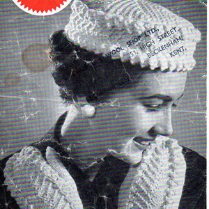 May include: A black and white photo of a woman wearing a white knitted pillbox hat and matching mittens. The hat and mittens have a textured, bobbly design. The text "WELDONS KNITWEAR 4D A1169" is visible in the top left corner of the image. The text "PILLBOX and MITTS Average Size Hat: 3 ozs. Double Knitting. Mitts: 3 ozs." is visible in the top right corner of the image. The text "CLA'S WOOL SHOP LTD., 251, HIGH STREET, BECKENHAM, KENT." is visible in the top right corner of the image.