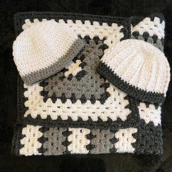 Black, grey and white baby  blanket, with 2 hats.