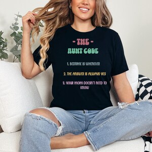 May include: Black t-shirt with the text "The Aunt Code" and three rules: "Bedtime is whenever", "The answer is always yes", and "Your mom doesn't need to know".