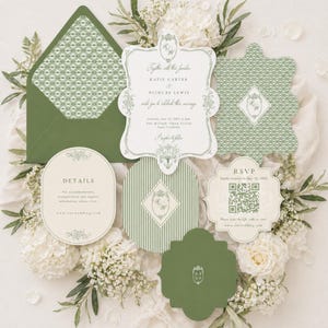 May include: An olive green wedding invitation suite with floral accents. The suite includes an invitation, RSVP card, details card, and envelope, all with matching design elements and the names "Katie Carter" and "Nicolas Lewis".