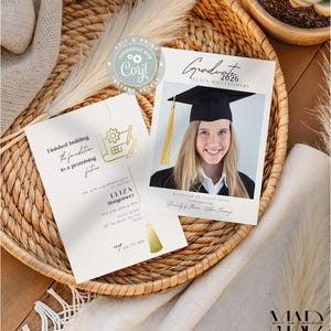 May include: Two graduation announcements on a woven tray. One features a photo of a graduate in a cap and gown, with the text "Graduate 2026." The other has text that reads "Finished building the foundation to a promising future."