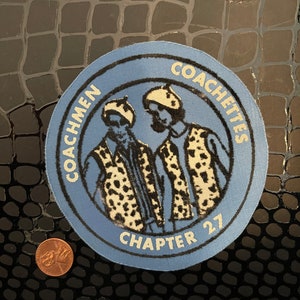 May include: Blue and white embroidered patch with the text "Coachmen Coachiettes Chapter 27" and a cartoon image of two people wearing leopard print vests.
