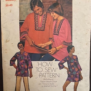 May include: A vintage Simplicity sewing pattern, number 5828, for a tunic top and trousers. The cover displays illustrations of the finished garments in shades of orange, pink, and floral patterns. The text on the cover reads 'How to Sew Pattern'.