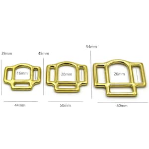May include: Three gold-colored metal buckles with different sizes. The buckles are 16mm, 20mm, and 26mm wide. The buckles are 39mm, 45mm, and 54mm long.