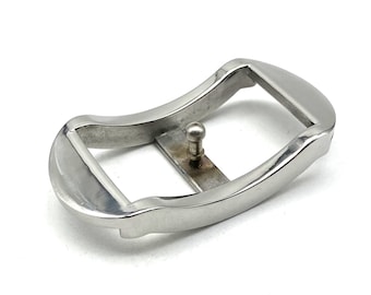 May include: A silver metal buckle with a curved design. The buckle has a small metal pin that goes through a hole in the strap.