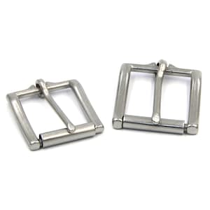 May include: Two silver metal belt buckles. The buckles are rectangular with a smooth, polished finish. They are designed to be used with a belt strap.