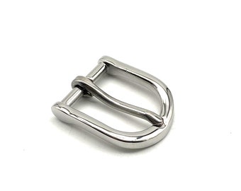 May include: A silver metal buckle with a smooth, rounded finish. The buckle has a simple, classic design.