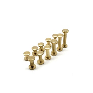May include: A collection of 12 brass standoffs, also known as spacers, in various sizes. The standoffs are arranged in a diagonal line on a white surface.