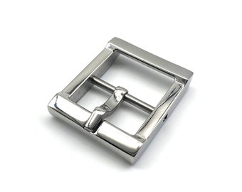 May include: A silver metal buckle with a rectangular shape and a smooth finish.