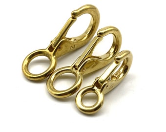 May include: Three gold-colored metal snap hooks of different sizes. The hooks are numbered 0, 1, and 2.