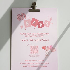 May include: Pink baby shower invitation with a pink and white polka dot background. The invitation says "oh baby" with pink blocks spelling out "baby". There is a QR code with the text "psssst... scan me to see our baby registry!" and a pink and white balloon illustration. The invitation also includes the date and time of the shower, the address, and the RSVP information.