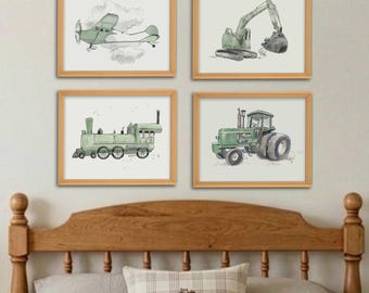 May include: A set of four framed wall art prints featuring watercolor illustrations of a green airplane, a green excavator, a green steam locomotive, and a green tractor, each displayed in a light wood frame against a neutral wall.