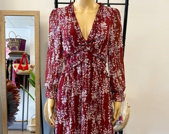 Chiffon boho midi dress with a V-neckline, long sleeves, and elastic waist in a burgundy color with a floral print.