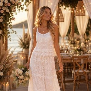 May include: A white two-piece outfit consisting of a sleeveless camisole top and a long tiered skirt, both featuring intricate floral lace embroidery, scalloped edges, and delicate crochet detailing throughout the fabric construction.