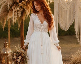 May include: A white floor-length dress featuring a V-neckline, long sheer sleeves with lace cuffs, and a lace bodice. The waist is accented with a thin cord tie featuring a tassel detail, and the skirt is made of a flowing, lightweight fabric.
