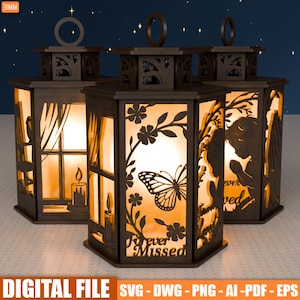 May include: Three dark brown, laser-cut lanterns with detailed designs. Each lantern has a unique silhouette, including a butterfly, angel, and candle. The text "Forever Missed" is visible on one lantern. The lanterns are lit from the inside.