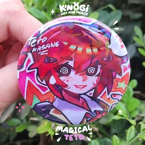 May include: A round button featuring a colorful anime-style illustration of a character with red hair and a smiling expression. The button has the text "Teto Kasane" and "Magical Teto" on it, with the artist's name "Knogi Art and Merch" at the top.