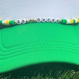 Inspired by the university of Oregon trucker hat, chain accessory. Green and yellow college accessory.