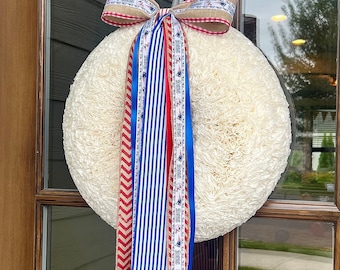 Conjunto de fitas Patriots com laço de mascote, vermelho, branco e azul.