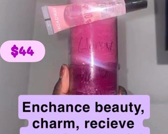 May include: A pink wax candle in a clear glass jar with a Broadway lip gloss tube resting horizontally across the top. The candle features handwritten text on the glass. Text overlays include D Glamour, $44, and Enchance beauty, charm, recieve attention, special treatment, makeover, glow, be beautiful.