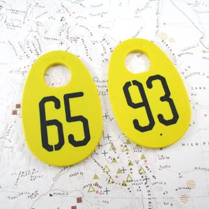 Pair of Vintage Yellow Texite Doublesided Cow Tags - 65 and 93