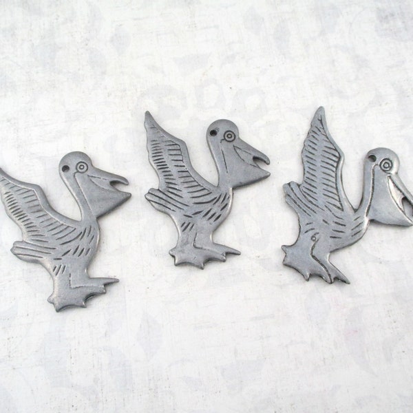 Three Vintage Pewter Pelican Ornaments