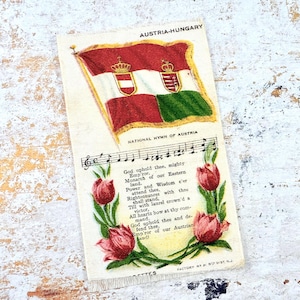 May include: Vintage postcard featuring the Austria-Hungary flag with a red, white, and green design. The postcard includes the text "National Hymn of Austria" and musical notes, along with red tulip illustrations.