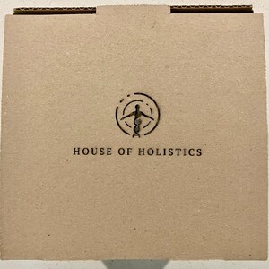 May include: A brown cardboard box with a logo that says "HOUSE OF HOLISTICS". The logo features a stylized human figure with a DNA strand.