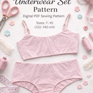May include: A light pink underwear set pattern for girls, including a bralette and briefs. The image features sewing notions like scissors, thread spools, and a measuring tape. The pattern is for sizes 7-10, equivalent to 122-140 cm.