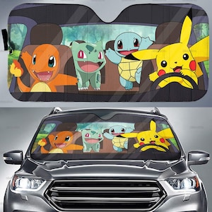 May include: A car sunshade featuring a colorful cartoon design of popular characters. The characters include a yellow Pikachu driving, with orange, green, and blue characters as passengers. The sunshade is designed to fit a car windshield.