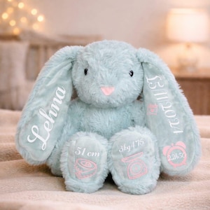 May include: A set of three ceramic mugs with a speckled, matte finish. The mugs are in shades of cream, light gray, and dark gray. Each mug has a simple, modern design and a rounded handle. The mugs are likely for coffee or tea.