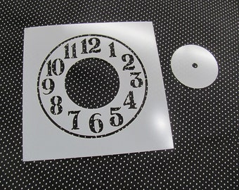 May include: White clock stencil with black numbers 1 through 12. The stencil is on a black background with white polka dots.