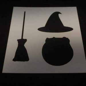May include: A stencil for crafting featuring a witch's hat, a cauldron, and a broom.