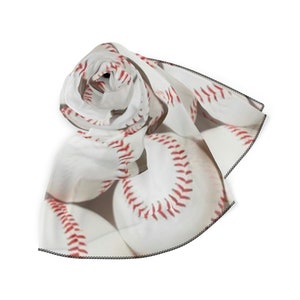 May include: White chiffon scarf with a repeating pattern of baseballs. The baseballs are white with red stitching.