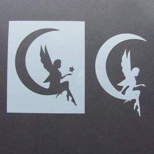 May include: Two stencils, one with a fairy sitting on a crescent moon holding a star, and the other with a fairy sitting on a crescent moon.