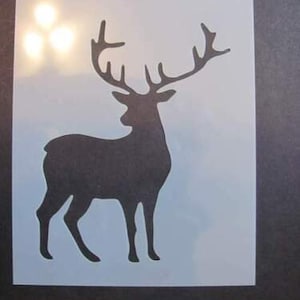 May include: A black silhouette of a deer with large antlers. The deer is standing on a white background. This is a stencil for crafting projects.