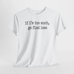 A white t-shirt with the text "if I'M TOO MUCH, go find less" printed on it.