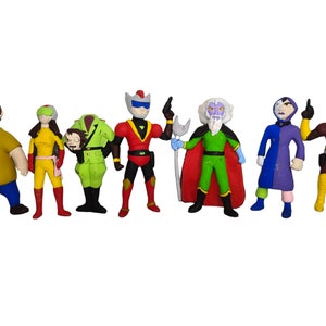 May include: A set of eight colorful action figures, including a green figure with a yellow helmet, a red figure with a yellow helmet, a yellow figure with a red helmet, a purple figure with a blue cape, a green figure with a red cape, a brown figure with a yellow helmet, a yellow figure with a red helmet, and a brown figure with a yellow helmet.