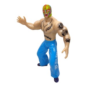 May include: A wrestler action figure with a colorful mask, tattoos, and blue pants with white lettering that says "619".