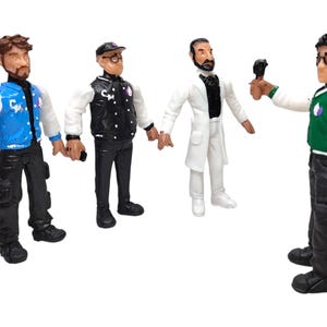 May include: Four toy figures of men wearing different outfits. The figures are all standing and facing forward. The figure on the left is wearing a blue and white jacket, black pants, and a black hat. The figure in the middle is wearing a black and white jacket, black pants, and a black hat. The figure on the right is wearing a white lab coat, white pants, and a black tie. The figure on the far right is wearing a green and white jacket, black pants, and a black hat.