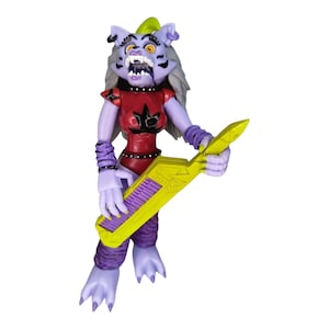 May include: Purple and white action figure of a cat-like creature with a yellow and purple keyboard. The figure is wearing a red and black outfit with a star pattern.
